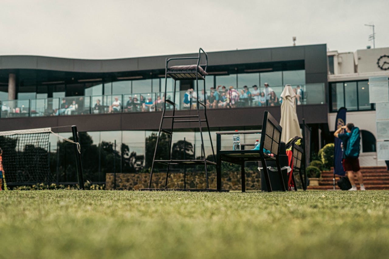 gallery-3 A vibrant tennis court scene with spectators in a modern facility in Melbourne, Australia.