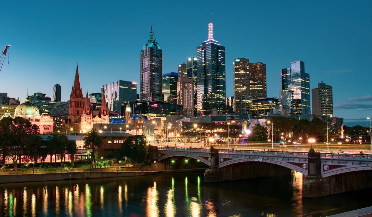 A captivating view of Melbourne's skyline reflected in the Yarra River during dusk.