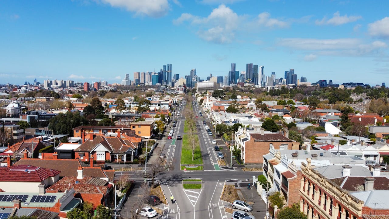gallery-2 Aerial view of Carlton North neighborhood with Melbourne's skyline under a clear day sky.