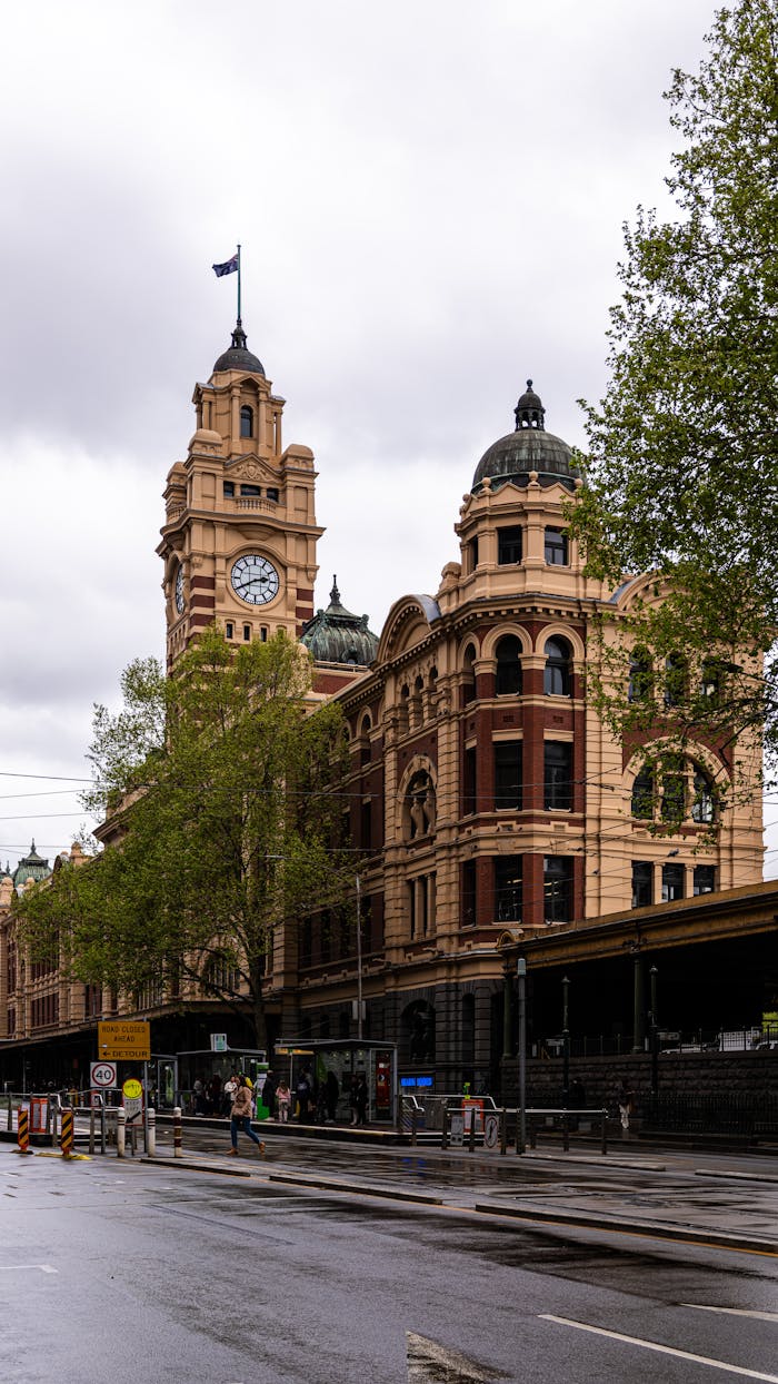 services-03 A cloudy day view of Melbourne's historical Flinders Street Station showcasing its iconic facade.